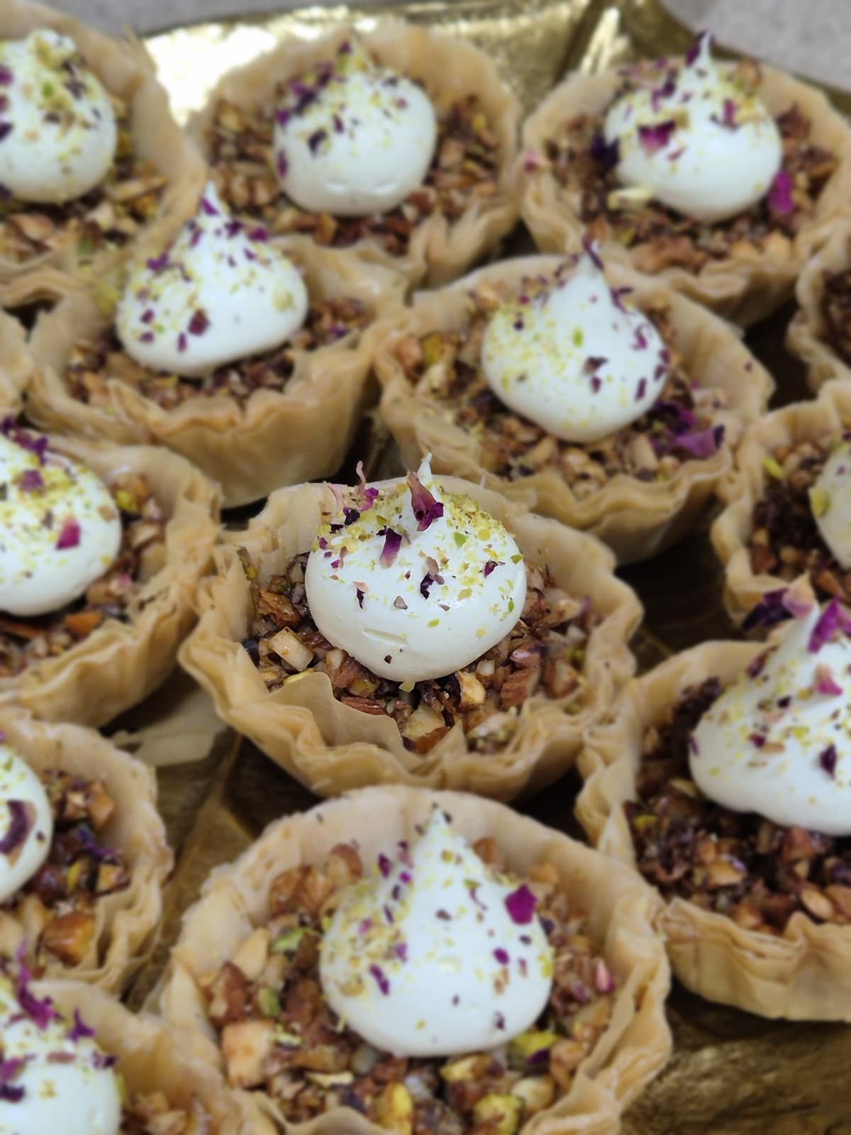 Baklava custard phyllo tarts with cream and rose petals
