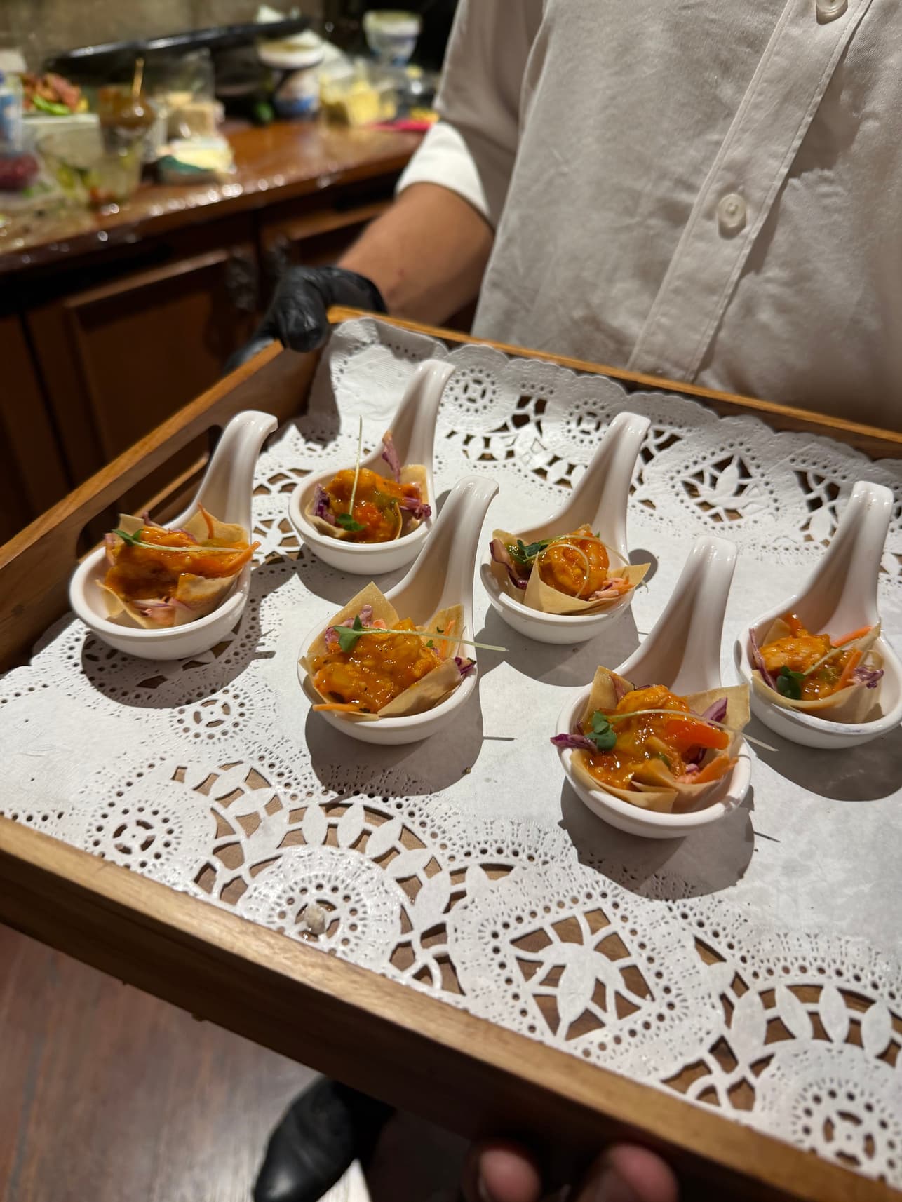 Pass-around seafood appetisers served in ceramic spoons