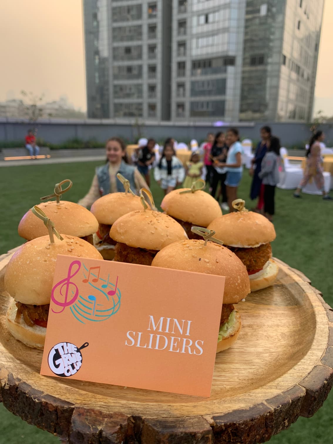 Mini sliders with menu card at a children's lawn party